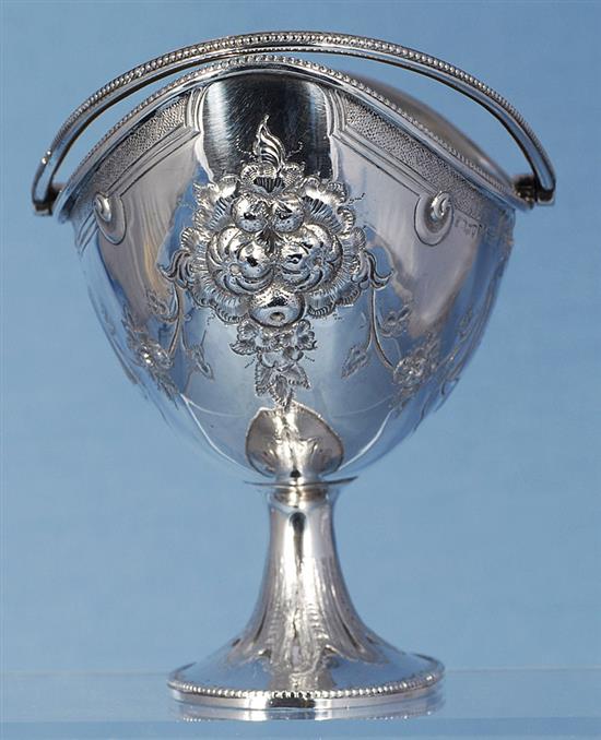 A Victorian silver swing handled sugar basket and sifter spoon, by Martin, Hall & Co, basket height 190mm, weight 7.7oz/241grms.